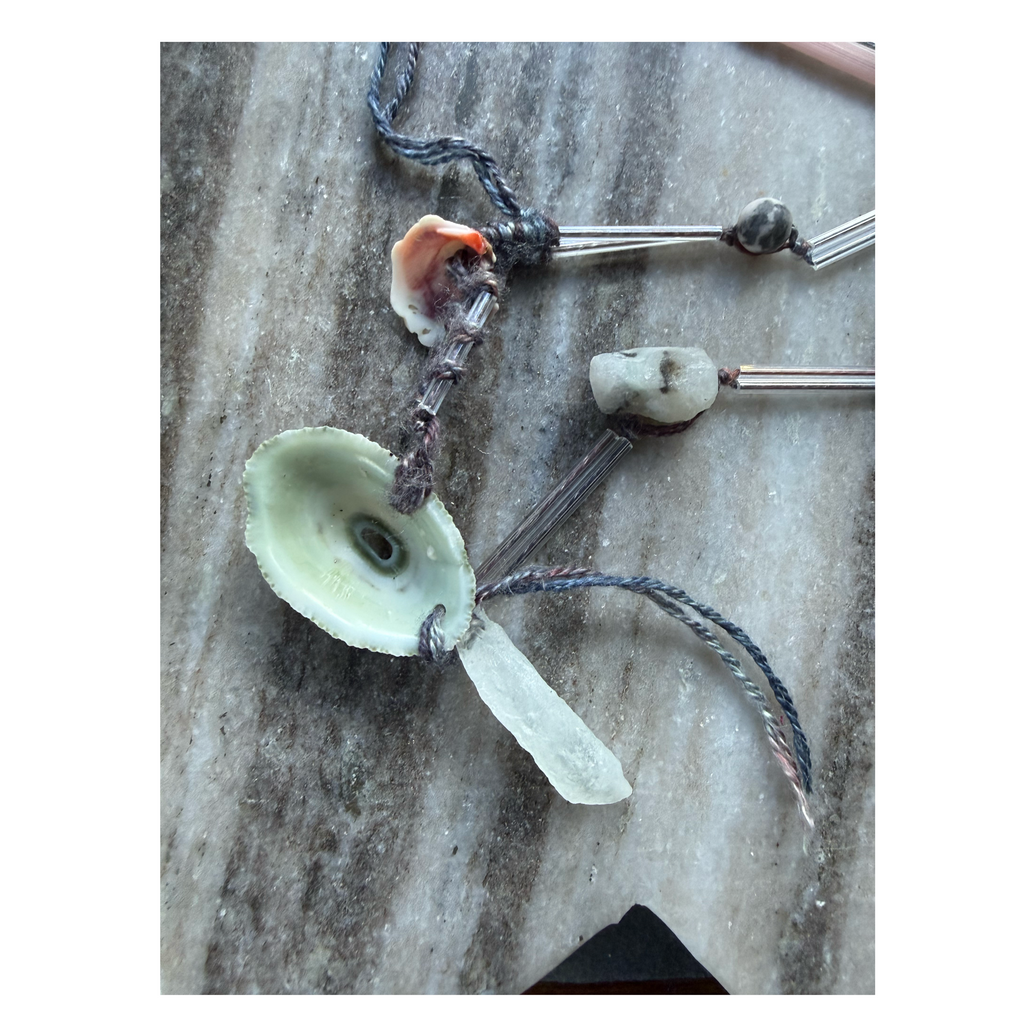 Necklace with urchin shell and clear quartz pendant on silk and glass
