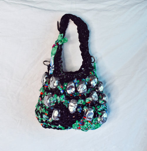 One-of-a-kind handmade baguette bag crocheted from black latex and repurposed Hawaiian shirt fabric with silver chrome details