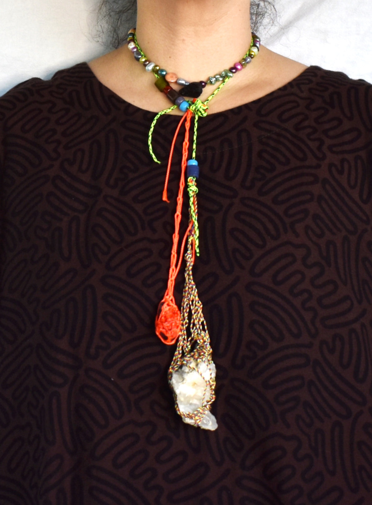 Convertible lariat necklace with fluorite, Tibetan quartz and neon paracord worn knotted at the neck