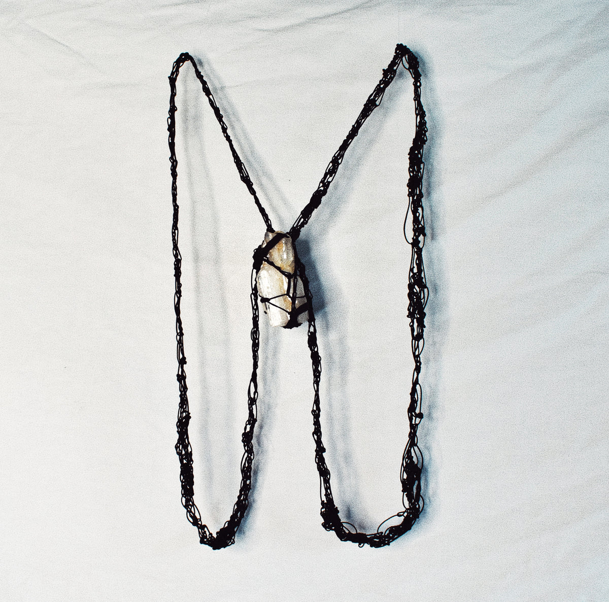 Handmade black crochet cord body harness and necklace with harnessed raw Tibetan quartz
