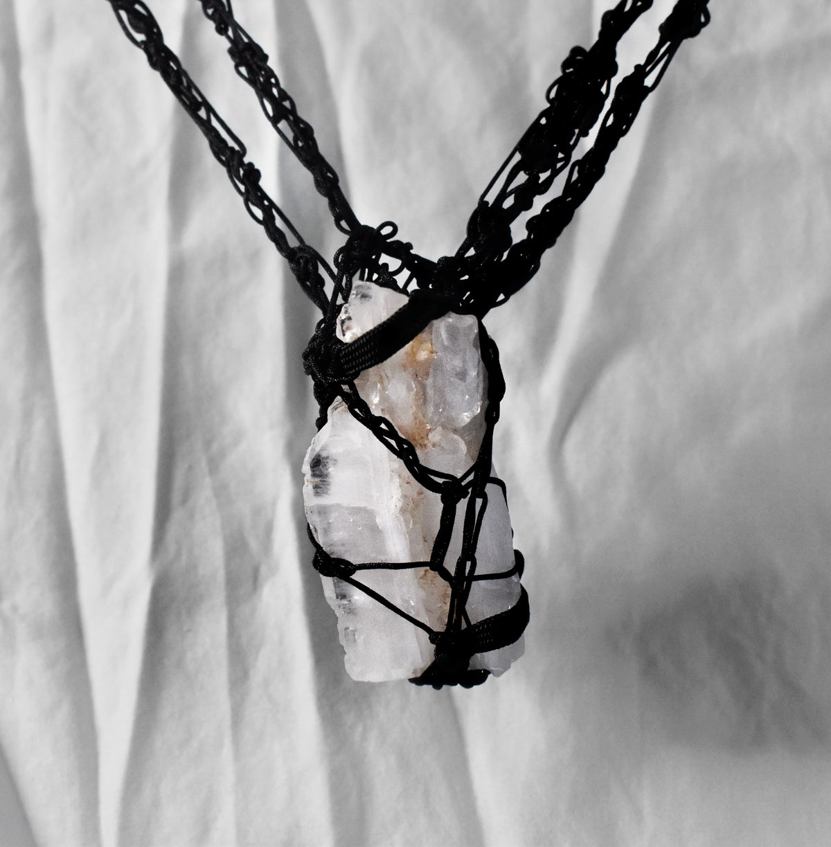 Close-up of raw Tibetan quartz wrapped in hand-crocheted black cord