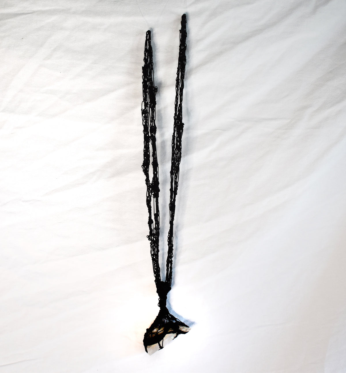 Convertible black cord necklace shown long with raw Tibetan quartz pendant