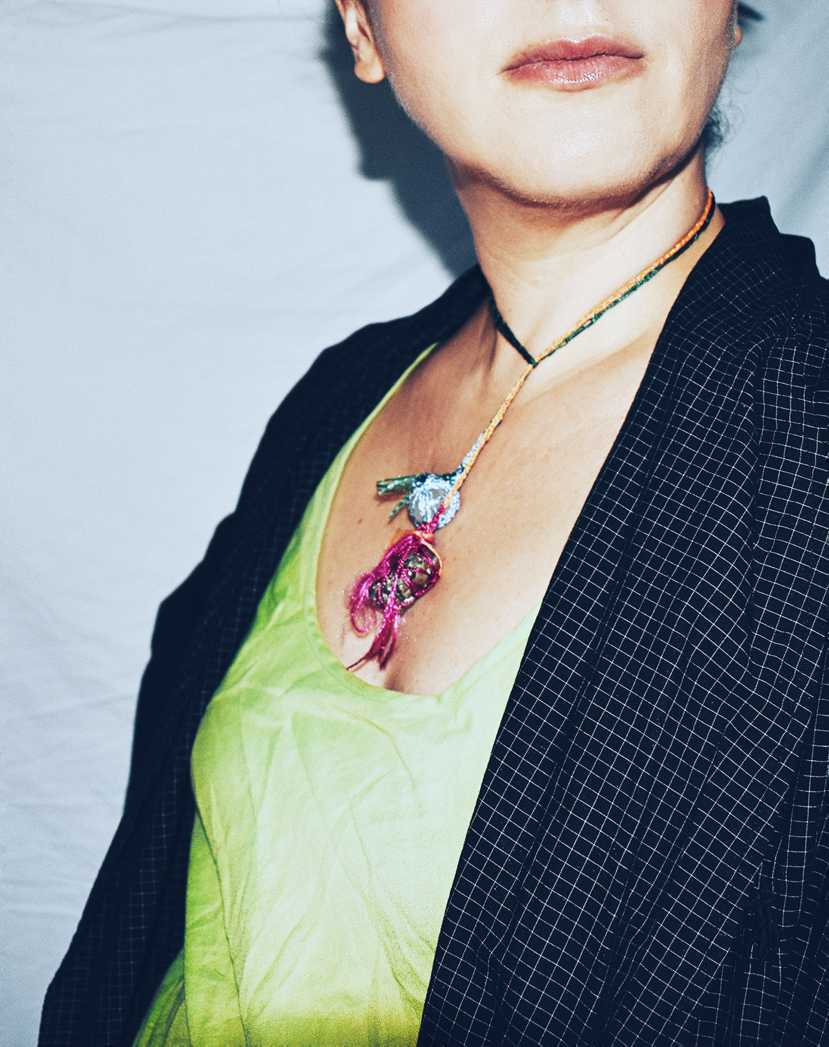 Multicolor crochet lariat necklace with raw pyrite and nephritic jade worn wrapped around the neck