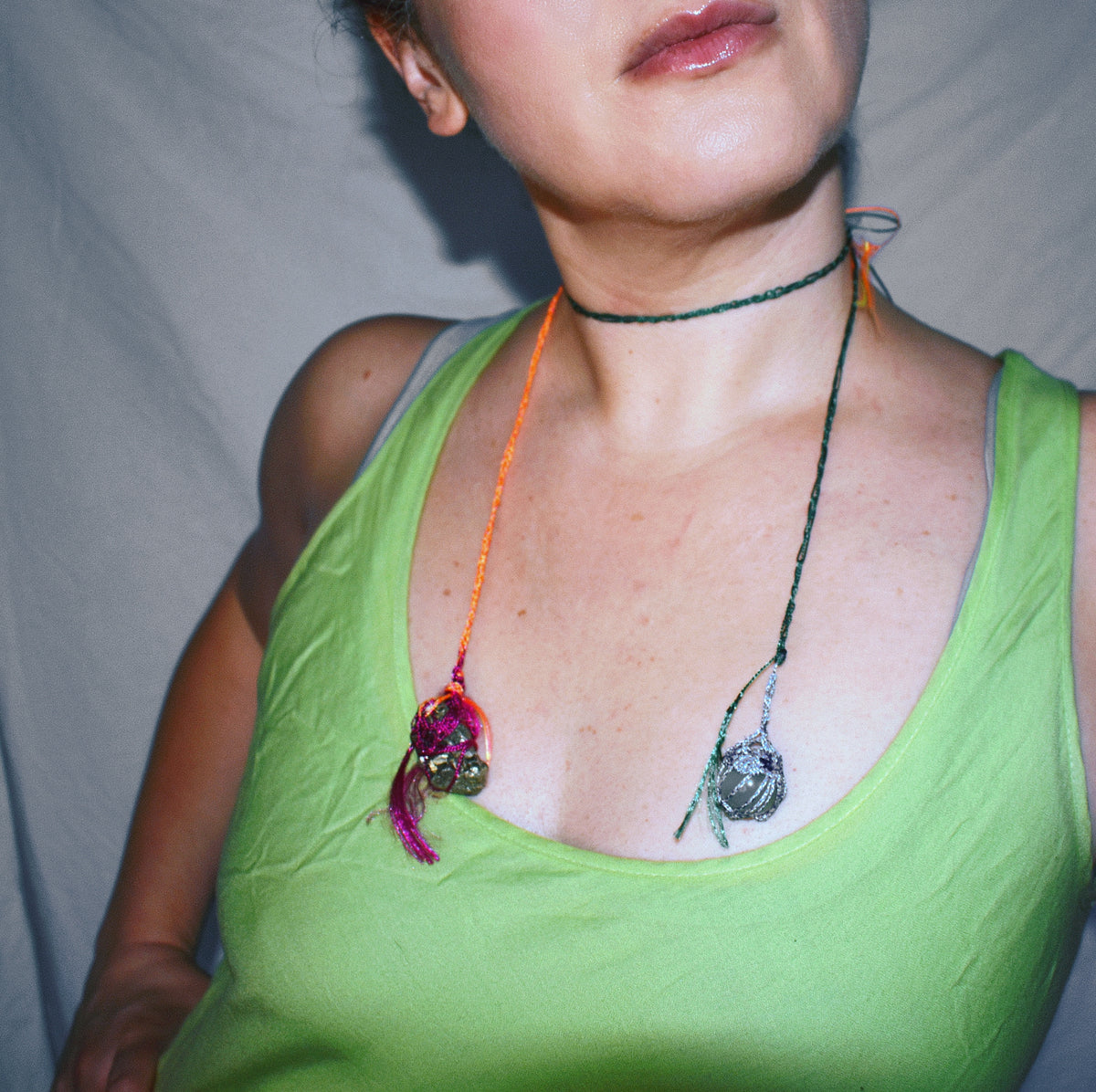 Convertible crochet lariat necklace worn asymmetrically with pyrite and jade pendants